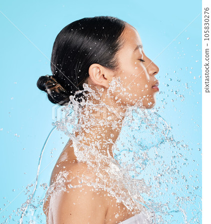 Beauty, water and face of woman on blue background for wellness, healthy skin and cleaning in studio. Skincare, shower and female person profile with splash for facial grooming, washing and body care Beauty, water and face of woman on blue background for wellness, healthy skin and cleaning in studio. Skincare, shower and female person profile with splash for facial grooming, washing and body care 105830276