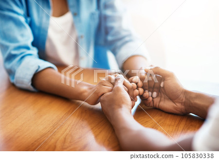 Empathy, care and hope with friends and holding hands for comfort, kindness and gratitude. Support, help and trust with closeup of people at home for depression during cancer, praying and forgiveness 105830338