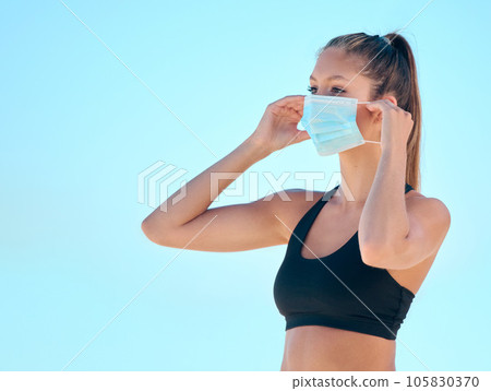 Fitness, outdoor and woman with a mask, exercise and workout with wellness, safety and health. Female person, girl or athlete with face cover, regulations or protection with sports, outside and goals 105830370