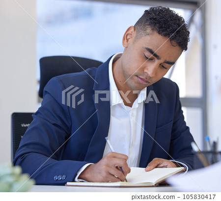 Ill jot that idea down for next time. Shot of a young businessman writing notes while working in an office. Ill jot that idea down for next time. Shot of a young businessman writing notes while working in an office. 105830417