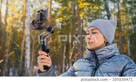 Woman Holding On Handheld Film 3-axis Gimbal Stabilization Devic Woman Holding On Handheld Film 3-axis Gimbal Stabilization Devic 105830471