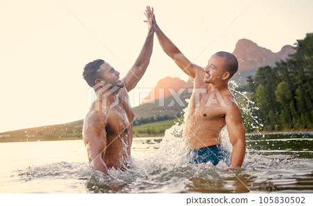 Lake, high five and swimming with man friends outdoor in nature for travel or adventure while on summer holiday. Motivation, water or wet with a young male traveler and best friend on vacation Lake, high five and swimming with man friends outdoor in nature for travel or adventure while on summer holiday. Motivation, water or wet with a young male traveler and best friend on vacation 105830502