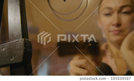 Woman artist learns to paint with airbrush with acrylic dye, paper and easel. Concept modern art, airbrushing, aerography, graffiti, aerosol spray Woman artist learns to paint with airbrush with acrylic dye, paper and easel. Concept modern art, airbrushing, aerography, graffiti, aerosol spray 105830587