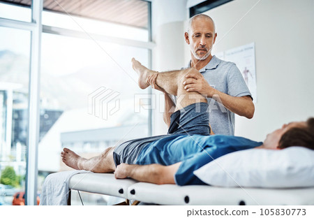Physical therapy, healing and patient with pain, leg and recovery with injury, accident and consultation. Male person, employee or chiropractor with customer, healthcare and physiotherapist with care Physical therapy, healing and patient with pain, leg and recovery with injury, accident and consultation. Male person, employee or chiropractor with customer, healthcare and physiotherapist with care 105830773