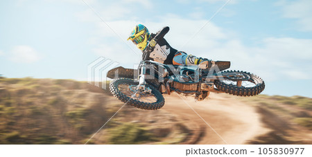 Motorcycle, fearless man and motorcross jump in desert, blue sky and freedom. Driver, cycling and offroad freedom of sports competition, motorbike performance or adventure course for fast action show Motorcycle, fearless man and motorcross jump in desert, blue sky and freedom. Driver, cycling and offroad freedom of sports competition, motorbike performance or adventure course for fast action show 105830977