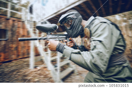 Paintball, black man and games, gun and target, sport with fitness and battlefield challenge, war soldier outdoor. Motion blur, extreme sports and exercise, shooting range and military mission 105831015
