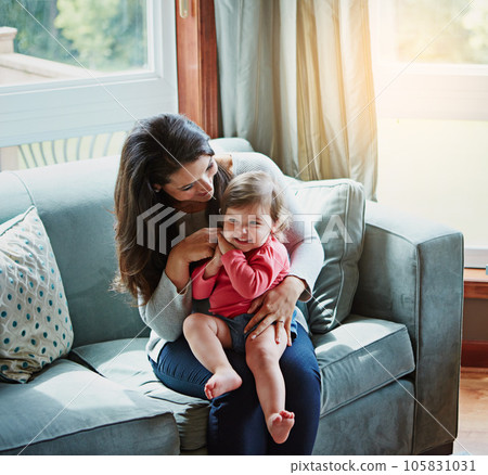 Relax, happy and smile with mother and baby on sofa for bonding, quality time and child development. Growth, support and trust with mom and daughter in family home for health, connection and care Relax, happy and smile with mother and baby on sofa for bonding, quality time and child development. Growth, support and trust with mom and daughter in family home for health, connection and care 105831031