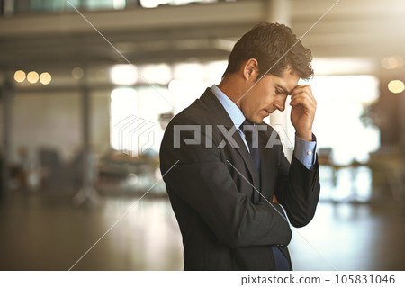 Headache, stress businessman standing and at his office sad or upset at debt fail at work. Mental health or anxiety, burnout and exhausted or depressed male corporate worker frustrated and tired 105831046