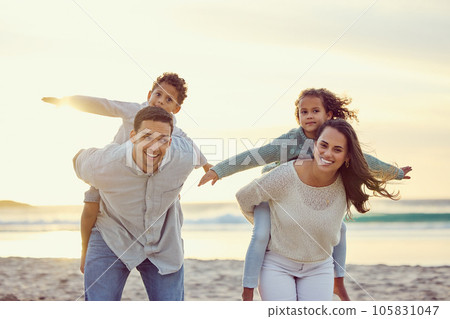 Mother, father and kids piggyback on beach for family holiday, summer vacation and weekend. Nature, travel and portrait of happy mom, dad and child playing by ocean for bonding, fun and quality time Mother, father and kids piggyback on beach for family holiday, summer vacation and weekend. Nature, travel and portrait of happy mom, dad and child playing by ocean for bonding, fun and quality time 105831047