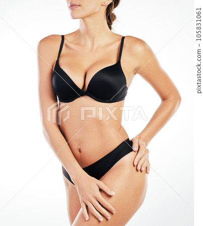 Tantalisingly tempting. an unrecognizable young woman posing in her underwear against a grey background in studio. 105831061