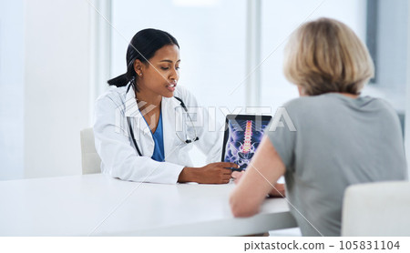 Doctor, woman and tablet with spine x ray, feedback or advice for injury, pain or talking with app for support. Medic, women and touchscreen for physiotherapy, osteoporosis and explain for healthcare Doctor, woman and tablet with spine x ray, feedback or advice for injury, pain or talking with app for support. Medic, women and touchscreen for physiotherapy, osteoporosis and explain for healthcare 105831104