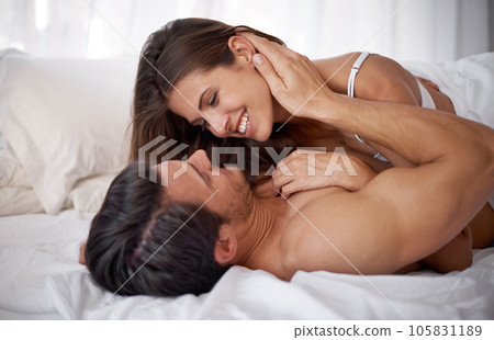 Bedroom love, morning and happy couple relax for calm peace, bonding and quality time together in Lisbon Portugal. Eye contact, vacation and romantic people on hotel bed for Valentines Day holiday Bedroom love, morning and happy couple relax for calm peace, bonding and quality time together in Lisbon Portugal. Eye contact, vacation and romantic people on hotel bed for Valentines Day holiday 105831189