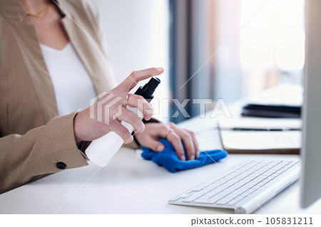 Keyboard sanitize, woman hand and spray at a desk for bacteria safety in a office. Business person, company and computer cleaner with bottle for covid, virus and germ protection against infection 105831211