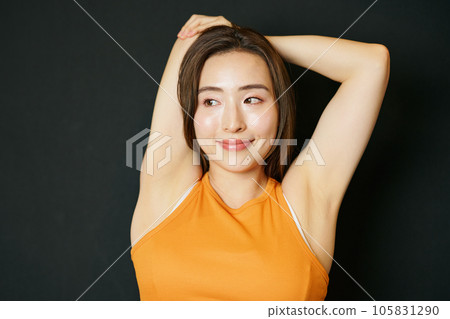 A woman wearing sportswear and stretching 105831290