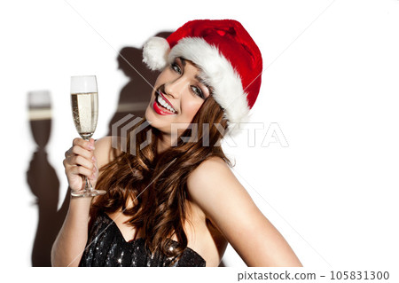 Party season is around the corner. Shot of a young woman celebrating christmas with champagne against a studio background. Party season is around the corner. Shot of a young woman celebrating christmas with champagne against a studio background. 105831300