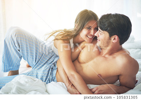 Love, bedroom hug and happy couple relax for morning peace, calm and bonding quality time together in Sydney Australia. Smile, vacation and romantic people in hotel bed for Valentines Day holiday 105831305