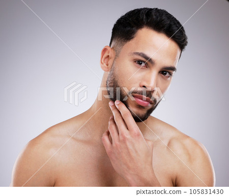 Skincare, beauty and portrait of man in a studio with a natural, grooming and face routine. Self care, beard trim and male model with a dermatology facial treatment for clear skin by gray background. 105831430