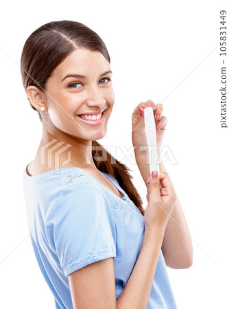 Pregnancy test, happy and portrait of a woman in a studio with good, exciting and positive news. Happiness, smile and young female model with a prenatal urine kit isolated by a white background. Pregnancy test, happy and portrait of a woman in a studio with good, exciting and positive news. Happiness, smile and young female model with a prenatal urine kit isolated by a white background. 105831449