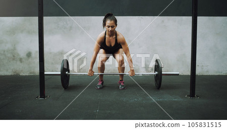 Weight lifting, fitness and woman with barbell for strong body in gym for training, exercise and workout. Sports, deadlift and female bodybuilder lift weights for challenge, wellness and strength 105831515