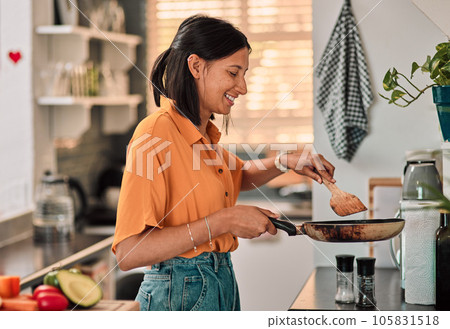 Food, kitchen and young woman cooking with a pan for lunch, dinner or supper in her apartment. Happy, young and female person preparing healthy, wellness or diet meal on the stove in her modern home. 105831518