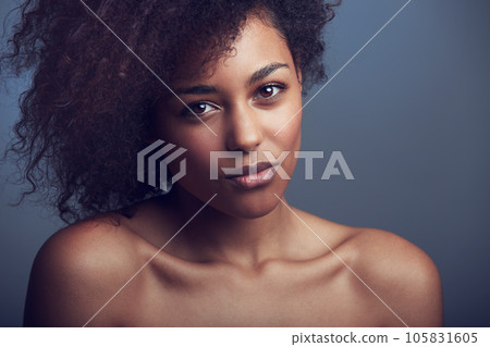 African woman, curly hair and studio portrait with makeup, cosmetics and health by dark background. Girl, model and wellness with skincare, natural aesthetic and glow on face with beauty by backdrop African woman, curly hair and studio portrait with makeup, cosmetics and health by dark background. Girl, model and wellness with skincare, natural aesthetic and glow on face with beauty by backdrop 105831605