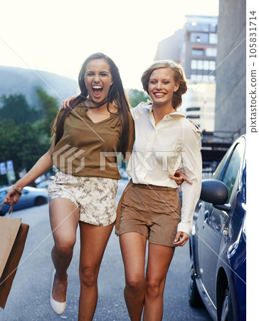 City portrait, woman walking or happy friends hug, excited and smile for shopping spree, store discount or deal. Retail bag, commute or women, people or customer happiness for fashion clothes product City portrait, woman walking or happy friends hug, excited and smile for shopping spree, store discount or deal. Retail bag, commute or women, people or customer happiness for fashion clothes product 105831714