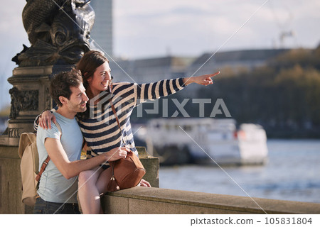 Travel, love and honeymoon with a young couple pointing while sightseeing on an overseas trip abroad together. Water, city and summer with a man and woman bonding or traveling in a foreign country Travel, love and honeymoon with a young couple pointing while sightseeing on an overseas trip abroad together. Water, city and summer with a man and woman bonding or traveling in a foreign country 105831804
