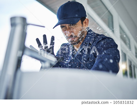 Plumbing, accident and asian man in bathroom with water splash, crisis or hand basin leak, fail or crisis. Faucet, emergency and male plumber with mistake, problem and pipe flood in home repairs 105831832