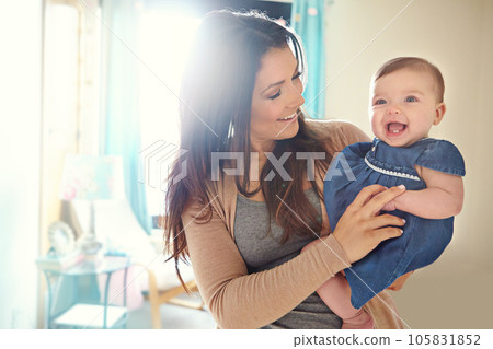 Mother, bonding or laughing baby girl in house living room or family home bedroom in support trust, security or love carrying. Smile, infant or happy mom holding child in funny or comic tickling game Mother, bonding or laughing baby girl in house living room or family home bedroom in support trust, security or love carrying. Smile, infant or happy mom holding child in funny or comic tickling game 105831852