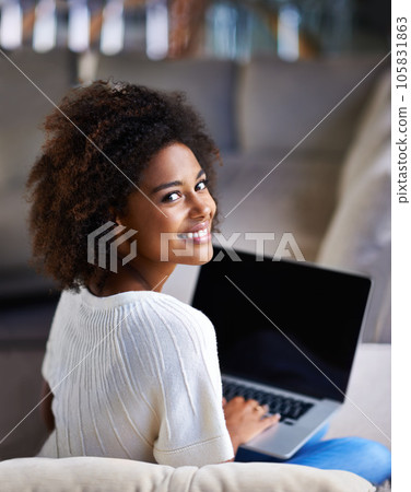 Portrait, smile and woman on a couch, laptop and connection for social media, happiness and relax at home. Face, female person and happy girl on a sofa, technology and search website for information 105831863