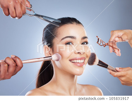 Hands with brush, makeup and portrait of woman in studio for wellness, beauty and cosmetics on blue background. Cosmetology, salon and face of girl for cosmetic application, foundation and products Hands with brush, makeup and portrait of woman in studio for wellness, beauty and cosmetics on blue background. Cosmetology, salon and face of girl for cosmetic application, foundation and products 105831917