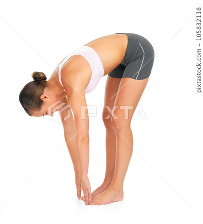 Fitness, exercise and woman stretching in a studio for wellness, healthy training and wellbeing. Sports, health and slim female model doing a warm up workout while isolated by a white background. Fitness, exercise and woman stretching in a studio for wellness, healthy training and wellbeing. Sports, health and slim female model doing a warm up workout while isolated by a white background. 105832118