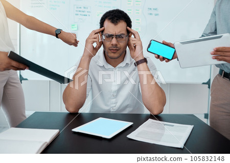 Please go away. Shot of a young businessman looking stressed out while working in a demanding office environment. 105832148