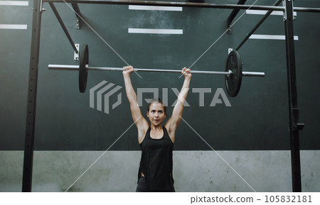 Weightlifting, fitness and woman with barbell in gym for training, exercise and workout for muscles. Sports, deadlift and female body builder lifting weights for challenge, wellness or strength 105832181