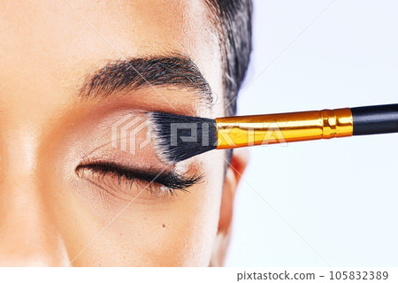 Beauty, makeup and brush with eye of woman in studio for cosmetics, product and eyeshadow. Salon, foundation and application with closeup of female model on white background for glow and self care Beauty, makeup and brush with eye of woman in studio for cosmetics, product and eyeshadow. Salon, foundation and application with closeup of female model on white background for glow and self care 105832389