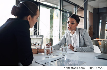 Were both on the same page today. Cropped shot of two attractive young businesswomen working together inside a modern office. Were both on the same page today. Cropped shot of two attractive young businesswomen working together inside a modern office. 105832556