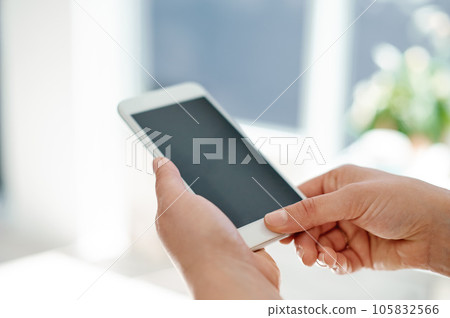 Modern business requires modern technology. Cropped shot of an unrecognizable businesswoman using her smartphone inside of an office. 105832566