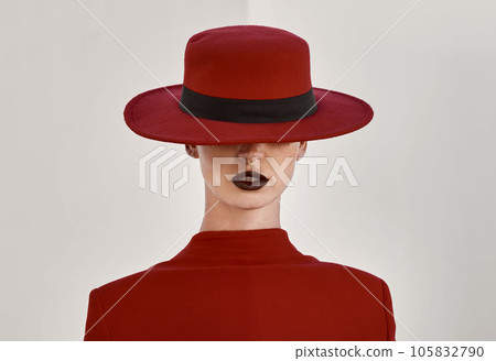 Beauty, style and classy model in a studio with a glamour, face and makeup routine. Stylish, classy and female person with fancy hat for accessory with elegant fashion isolated by white background. Beauty, style and classy model in a studio with a glamour, face and makeup routine. Stylish, classy and female person with fancy hat for accessory with elegant fashion isolated by white background. 105832790