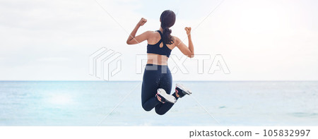 Back, freedom and fitness woman jump at the beach with celebration after running, training or workout success in nature. Exercise, jumping and behind female at the sea celebrating goal milestone Back, freedom and fitness woman jump at the beach with celebration after running, training or workout success in nature. Exercise, jumping and behind female at the sea celebrating goal milestone 105832997