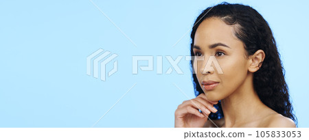 Skincare, woman and thinking face in studio for beauty, dermatology and mockup ideas on blue background. Young female model dream of cosmetics, aesthetic wellness and vision of facial transformation 105833053