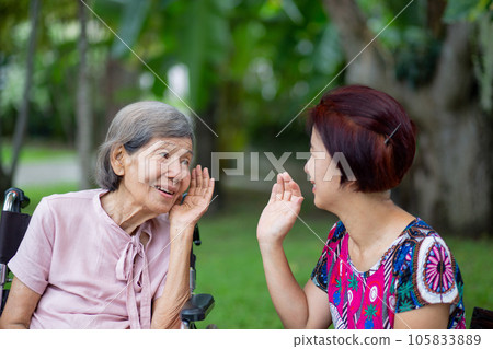 Asian seniors woman hearing loss , Hard of hearing try to talk with daughter. Asian seniors woman hearing loss , Hard of hearing try to talk with daughter. 105833889