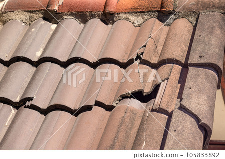 Damaged old roof tile in need of repair. Damaged old roof tile in need of repair. 105833892