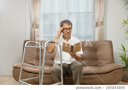 Sarcopenia older man is reading a book for relax at nursinghome . Sarcopenia is a degenerative disease of the muscle usually caused by the natural consequence of aging. 105833893