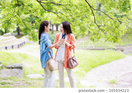 Image of a middle-aged women's trip strolling through a park in a tourist spot 105834223