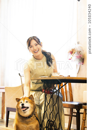 Dock cafe young woman Shiba Inu looking at the camera Dock cafe young woman Shiba Inu looking at the camera 105834240