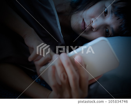 Woman Sleep on Bed and Looking Mobile in Night,She Wait Call Back from Husband with Sad and stressed,Lonely,Girl Unhappy Broken Heart and Problem,Authentic Black Hair and Skin Tan Asian. Woman Sleep on Bed and Looking Mobile in Night,She Wait Call Back from Husband with Sad and stressed,Lonely,Girl Unhappy Broken Heart and Problem,Authentic Black Hair and Skin Tan Asian. 105834746