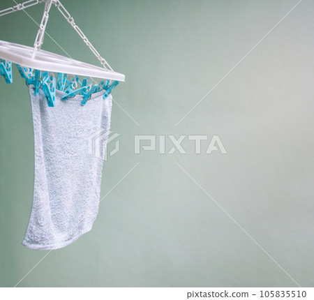 Drying Clothes under Clothes Line on Cement Wall Background Free Space,Dry Towel Clean handing clothesline. Drying Clothes under Clothes Line on Cement Wall Background Free Space,Dry Towel Clean handing clothesline. 105835510