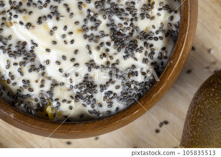 yogurt with the addition of pieces of ripe yellow kiwi with chia and popcorn yogurt with the addition of pieces of ripe yellow kiwi with chia and popcorn 105835513