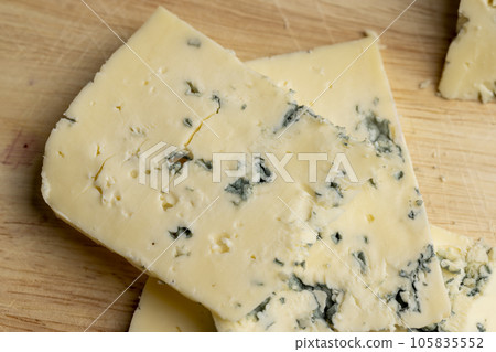 Cheese with blue mold cut into pieces Cheese with blue mold cut into pieces 105835552