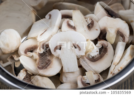 sliced mushrooms during cooking dishes with champignons sliced mushrooms during cooking dishes with champignons 105835569